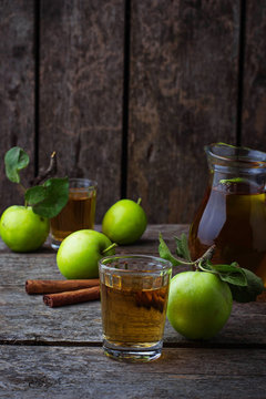 Glasses with apple juice on wooden table