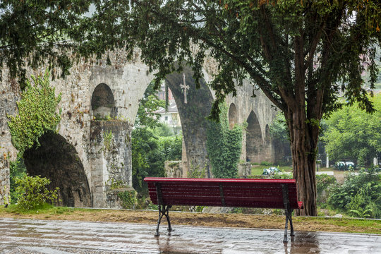 Red bench and secondly the old stone bridge in Cangas de Onis, A