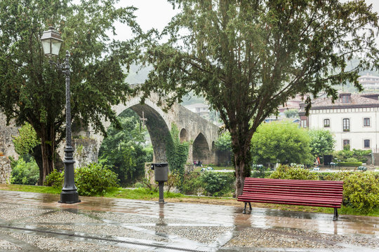 Red bench and secondly the old stone bridge in Cangas de Onis, A