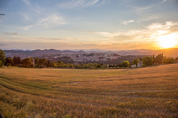 Fototapeta na wymiar Wide angle on Urbino during sunset in a summer day from the hill