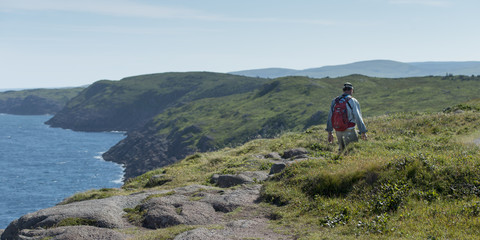 Man hiking, Avalon Peninsula, Newfoundland, Canada