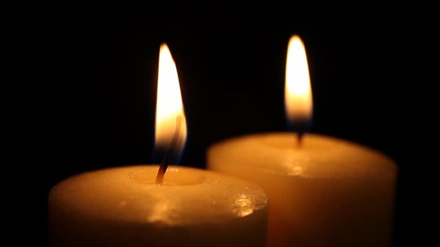 A close up shot of two candles with a shallow depth of field. HD 1080.