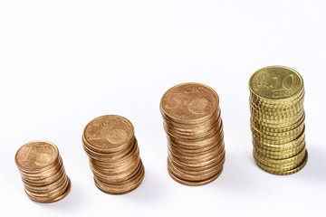 Different eurocent coins stacked in columns, on white. Blank space at top