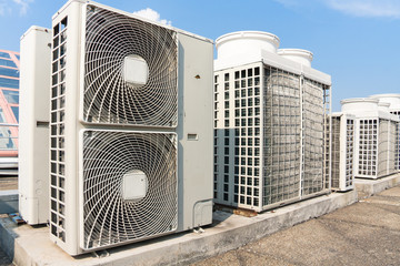 Industrial air conditioner condensers (outside unit) on the roof of a building on a hot summer day