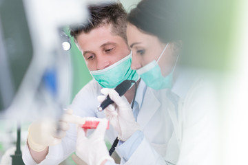 Dental prosthesis, dentures, prosthetics work. Dental students while working on the denture, false teeth, a study and a table with dental tools.