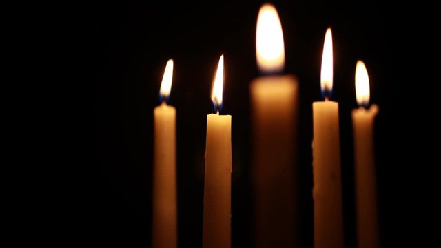 A shot of five candles with focus on the outer candles and space for text