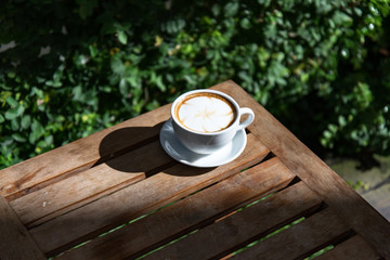 Coffee cup on wooden table ,soft focus
