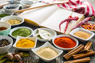 Various spices and blank cookbook.