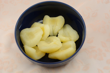 Canned sliced and pitted pears in blue bowl