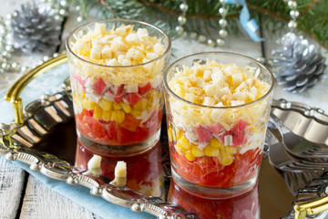 Salad with tomatoes, crab sticks, corn and crackers on the Chris