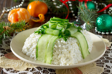 Christmas salad with meat and mushrooms, cucumber decoration bow