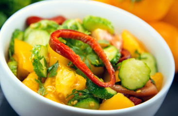 Close Up of colorful salad from tomatoes, cucumbers, peppers and