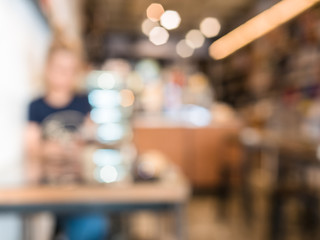 woman sitting in cafe, blurred bokeh for background