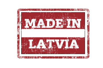 MADE IN LATVIA word written on red rubber stamp and flag with grunge edges.
