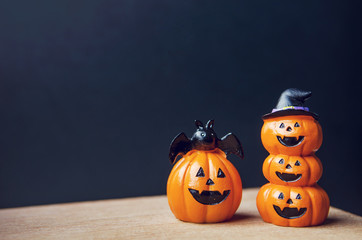Happy Halloween, Two Pumpkin on table wood with dark wall background, halloween concept. Copy space.