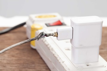 Closeup the Broken Smart Phone Charger Cable on Wooden Backgroun