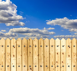 Wooden fence against blue sky background