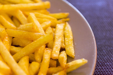French fries in a brown plate on the coverings