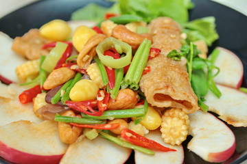 Chinese Vegetable festival  food as fried cashews nut and ginkgo with mixed vegetables,  "J food festival".   Have text space on left. Selective focus.