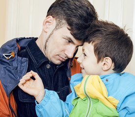 young handsome father with his son fooling around at home, lifestyle people concept