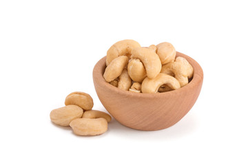 cashew nuts in wooden bowl isolated on white background