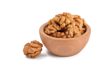 peeled walnuts in a wooden bowl, isolated, white background
