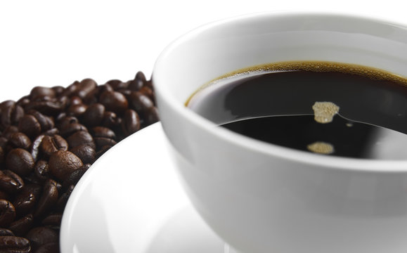 dark coffee in white cup with beans, isolated