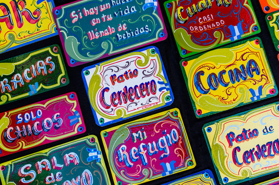 Colorful door signs in fileteado style