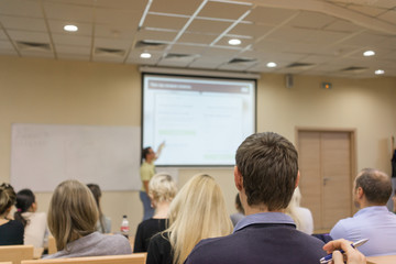 Naklejka na ściany i meble education, high school, teamwork and people concept - teacher standing in front of students and showing graphs on white board in classroom