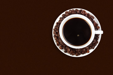 dark coffee with beans on brown table background