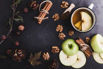 Frame of autumn leaves, chestnuts and ingredients for spiced tea