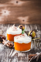 Homemade autumn dessert of pumpkin mousse with whipped cream
