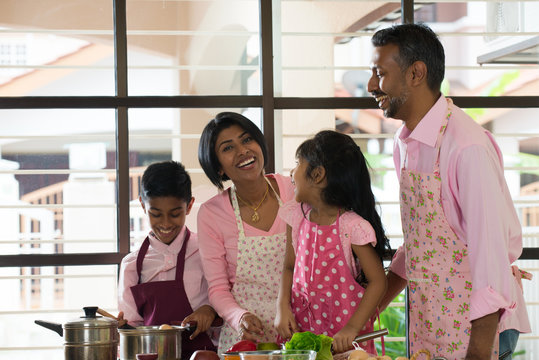 indian family spending quality time busy cooking at home
