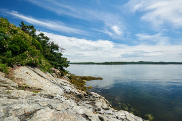 Rocky coast in Maine with the ocean and the sky in the background