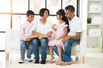 happy indian family eating pizza at home