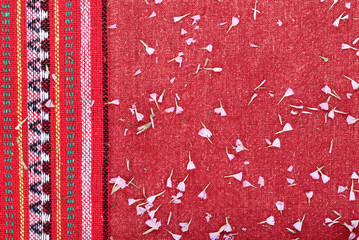 Beautiful flowers on a red fabric.