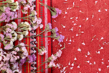 Beautiful flowers on a red fabric.