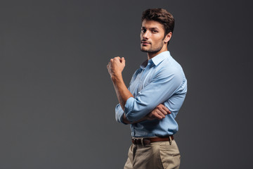 Side view of a successful handsome man with arms folded