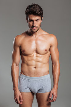 Portrait of a focused handsome muscular man in underwear standing