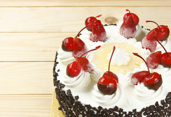 top view ice cream cake with strawberry, cherry, pineapple, choc