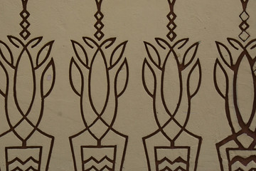 botanical brown pattern on a yellow concrete wall