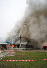 Fire and strong smoke covered building