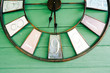 Antique Clock Decorated on a Green Wooden Wall
