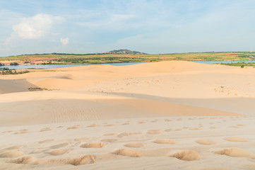 White sand dunes in desert on sunrise