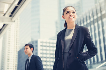 Fototapeta premium Businesswoman and businessman on blur building background