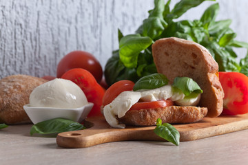 Sandwich with mozzarella, tomato and basil