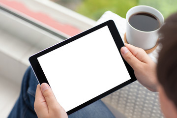 man hands holding tablet computer with isolated screen and coffe
