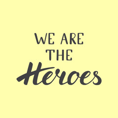 Calligraphic phrase "we are the heroes" on yellow background