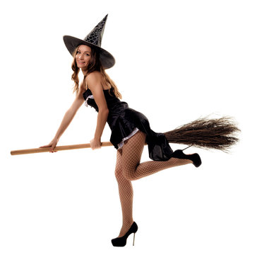 young woman in a witch costume posing in studio