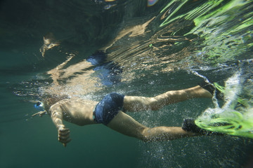 Fototapeta premium A diver in flippers snorkeling.